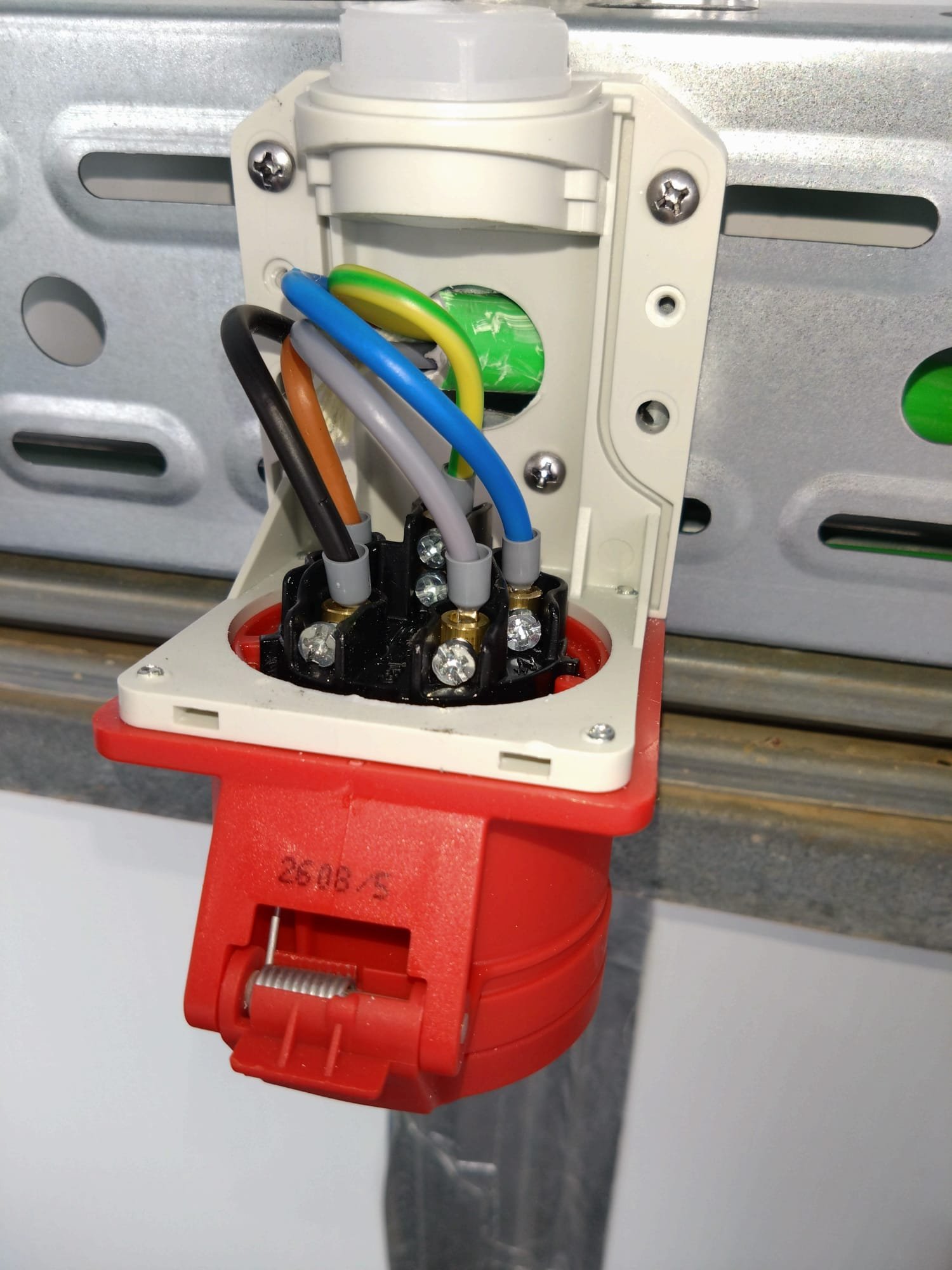 Red 400 V industrial socket being wired